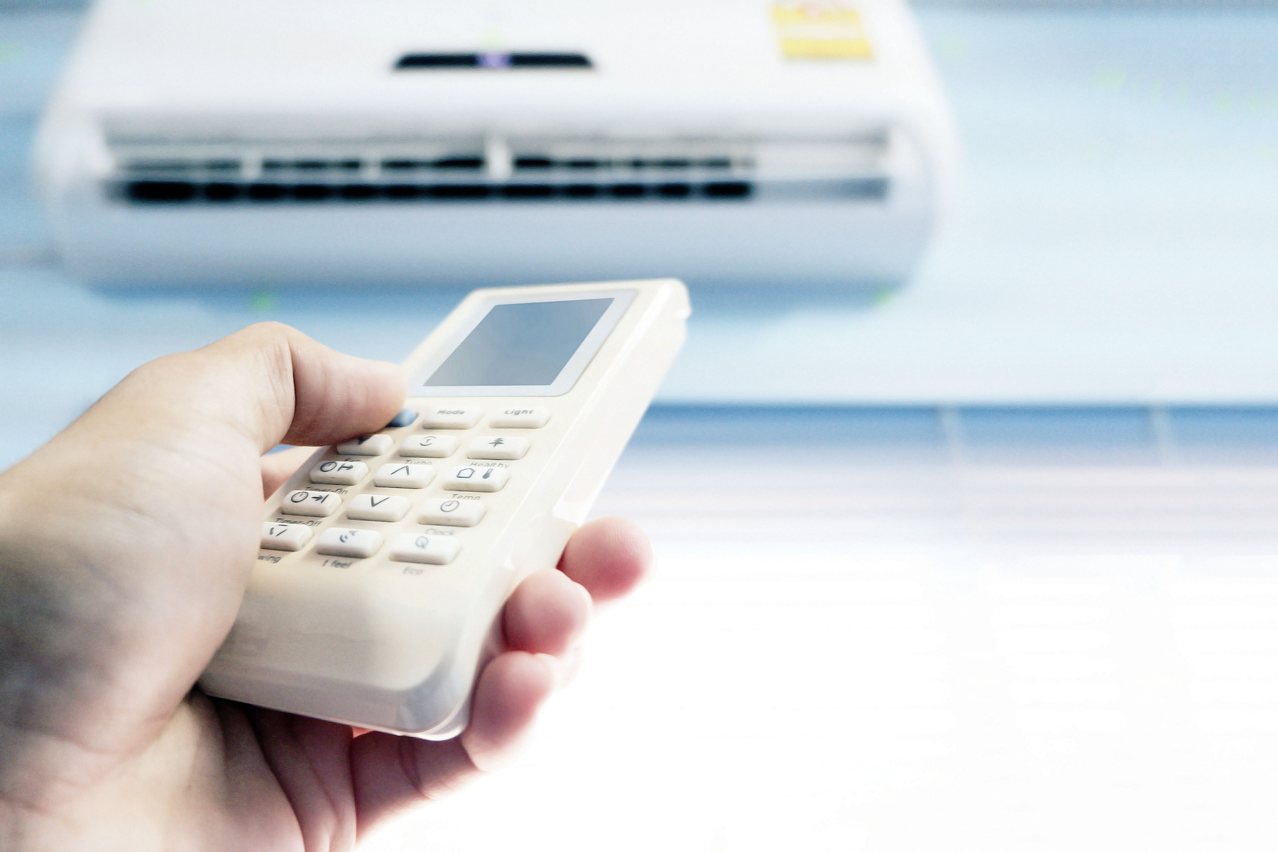 Person Using Remote Control for Airconditioner